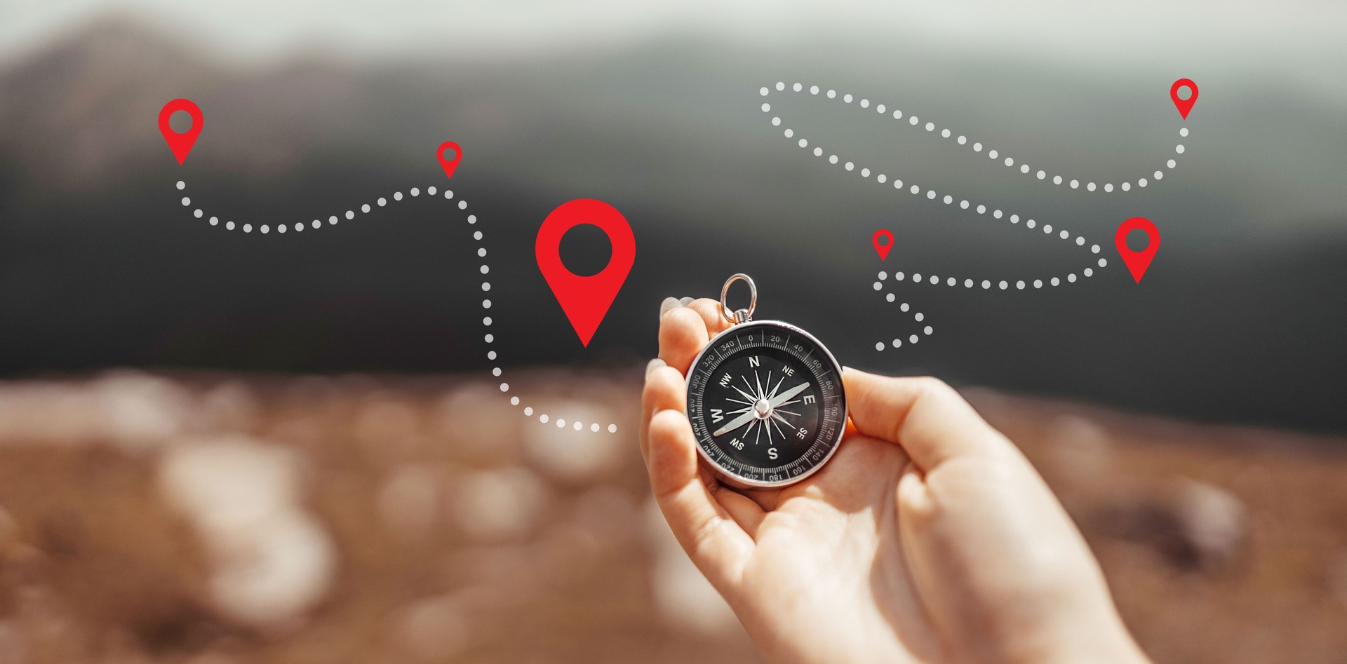 Traveler hand holds a compass on the beautiful Carpathian mountains view in sun. Horizontal banner with place for text. Vacation and travel