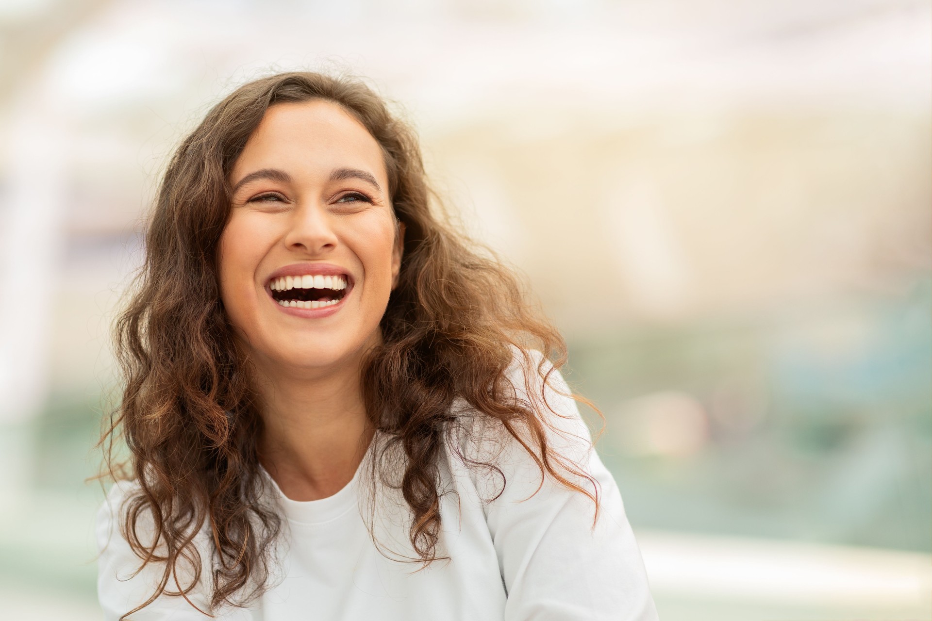 Closeup shot of beautiful young woman happily laughing